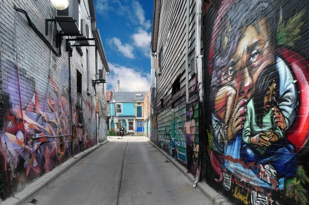A brick wall in Kensington Market painted end to end with a bright mural